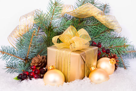 Gold gift box with ribbon and bow isolated. Christmas presentの写真素材