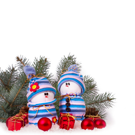 Christmas ornaments cheerful snowmen on Christmas tree. Christmas border with ornament, present and snowの写真素材