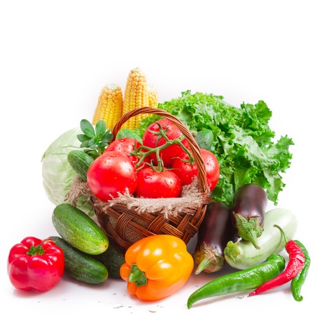 vegetables tomatoes, cucumbers, peppers in basket isolated on white macro.の写真素材