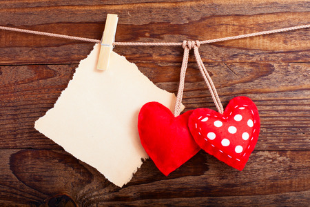 Valentines Vintage Handmade Hearts over Wooden Background. Valentine over Wood. Retro Styled Wallpaper. Valentines Day. Paper Tag labeling.の写真素材