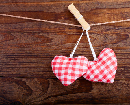 Valentines Vintage Handmade Hearts over Wooden Background. Valentine over Wood. Retro Styled Wallpaper. Valentines Day. Paper Tag labeling.の写真素材