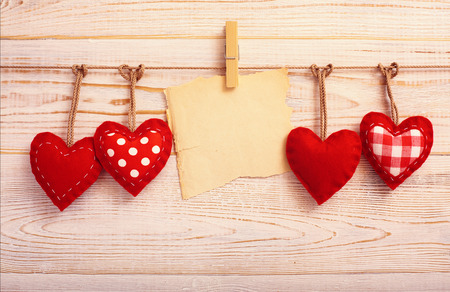 Valentines Vintage Handmade Hearts over Wooden Background. Valentine over Wood. Retro Styled Wallpaper. Valentines Day. Paper Tag labeling.の写真素材