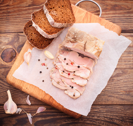 nice juicy meat with spices and bread on wooden tableの写真素材