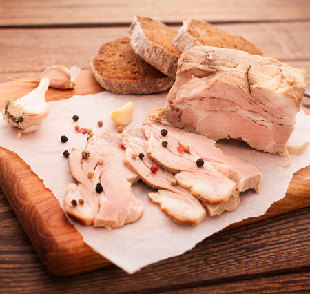 nice juicy meat with spices and bread on wooden tableの写真素材