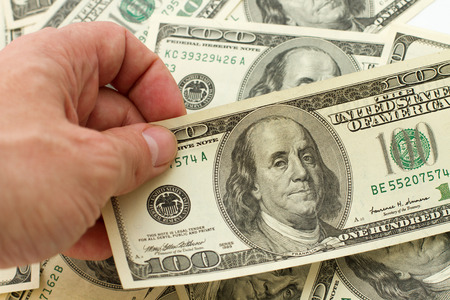 concept of financial success. businessman holding cash dollarsの写真素材