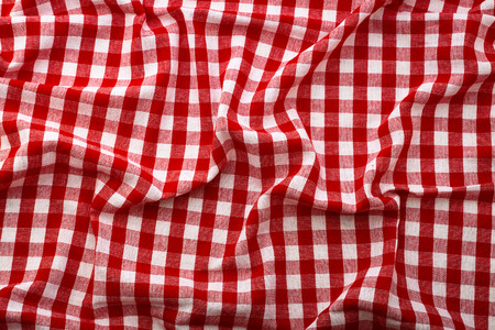 Wrinkled tablecloth red tartan in cage texture wallpaper. Unique perspectives top view.の写真素材