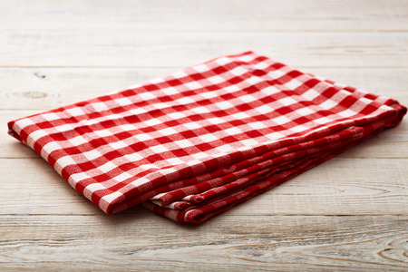 Top view of checkered tablecloth on white wooden table. Unique perspectivesの写真素材
