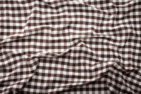 Wrinkled tablecloth red tartan in cage texture wallpaper. Unique perspectives top view.の写真素材