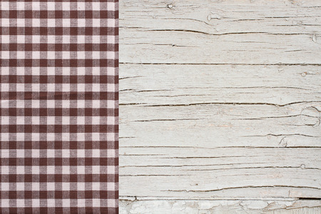 Top view of checkered tablecloth on white wooden table. Unique perspectivesの写真素材