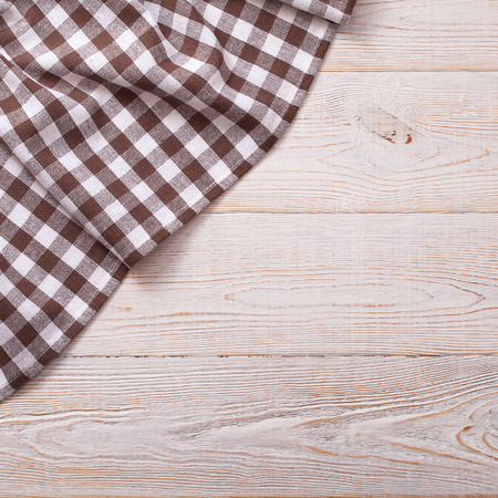 Top view of checkered tablecloth on white wooden table. Unique perspectivesの写真素材