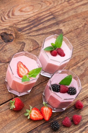 Drink smoothies summer strawberry, blackberry, raspberry on wooden table.の写真素材