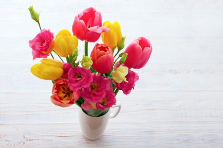 Bouquet of spring flower tulips on white wooden backgroundの写真素材