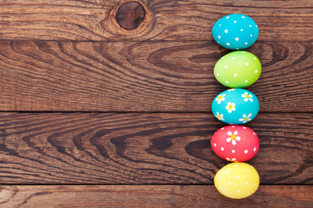 Easter eggs in basket with spring flowersの写真素材