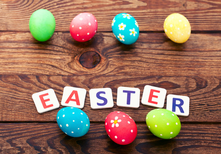 Easter eggs in basket with spring flowersの写真素材