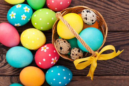 Easter eggs in basket with spring flowersの写真素材