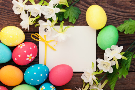 Easter eggs in basket with spring flowersの写真素材