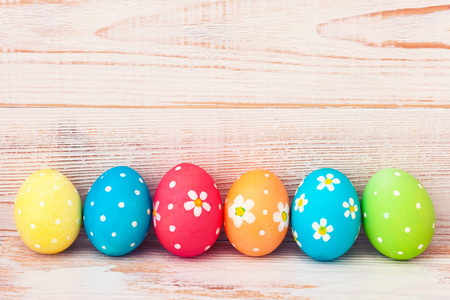 Easter eggs in basket with spring flowersの写真素材