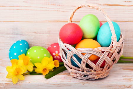 Easter eggs in basket with spring flowersの写真素材