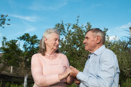 Senior couple embracing each other in countryside spring. Happy couple outdoors.の写真素材