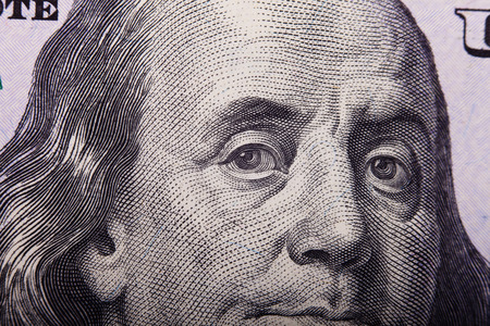Portrait of Benjamin Franklin from one hundred dollars bill new edition closeup conceptual backgroundの写真素材