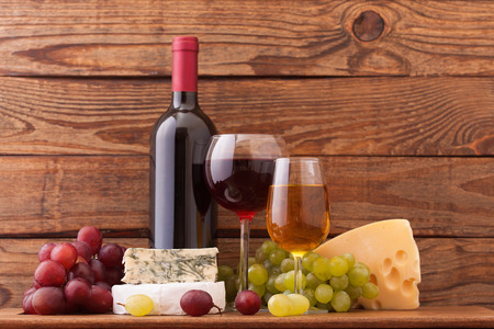 Wine and cheese on wooden background. Flat mock up for design.の写真素材