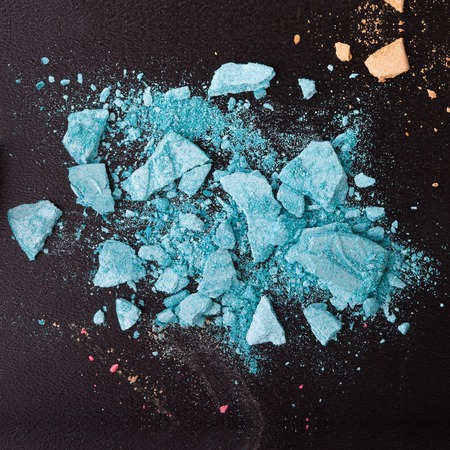 Background with colorful powder. Crushed eyeshadow on black background. Abstract backgroundの写真素材