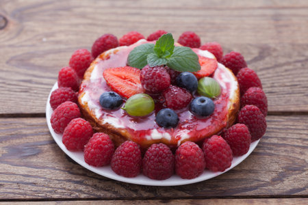 Cheese cake with berries on wooden table. Selective focusの写真素材