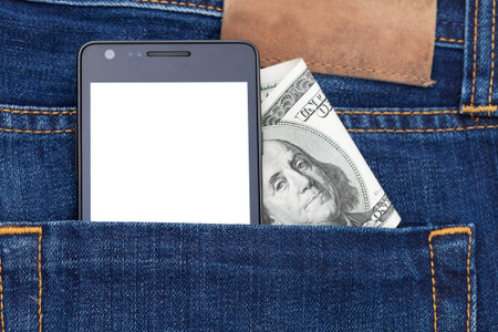 Modern phone in jeans pocket displaying white screen application. Cash dollars from pocket watch