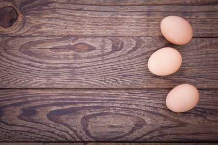 eggs on wooden background close up top viewの写真素材