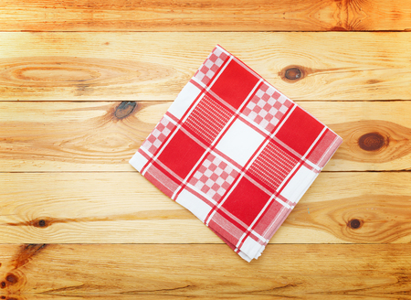 Wooden kitchen table with empty red tablecloth for dinner. View from above with copy spaceの写真素材