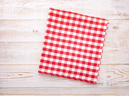 Wooden kitchen table with empty red tablecloth for dinner. View from above with copy spaceの写真素材