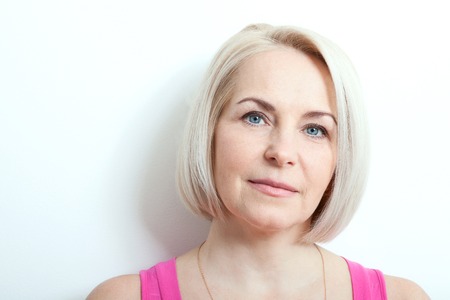 Magnificent portrait of beautiful middle aged woman with perfect skin closeup. Portrait of elegant middle aged womanの写真素材