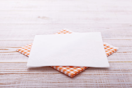 paper napkin on old wooden table close up. place for text