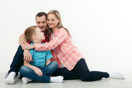 happy family mother and father playing with baby at homeの写真素材