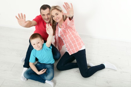 happy family mother and father playing with baby at homeの写真素材