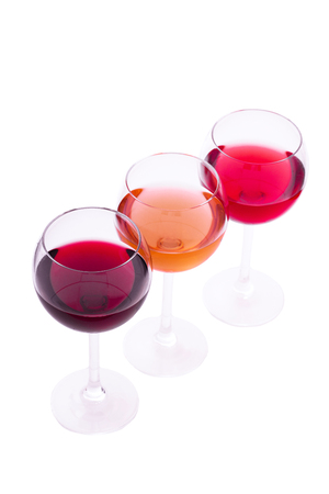Red, white and rose wine glasses up on white isolated. Top view..の写真素材