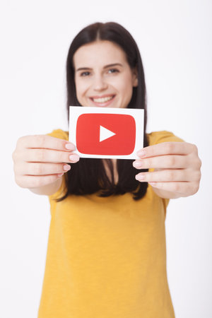 KIEV, UKRAINE - August 22, 2016: Woman hands holding paper with YouTube logotype icon printed on paper. YouTube is video-sharing website headquartered in San Bruno, California.のeditorial素材