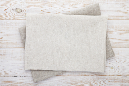Napkin white. Stack of grey dish towels on white wooden table background top view, mock up.の写真素材