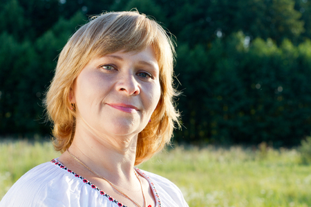 Happy woman smiling in the nature background.の写真素材
