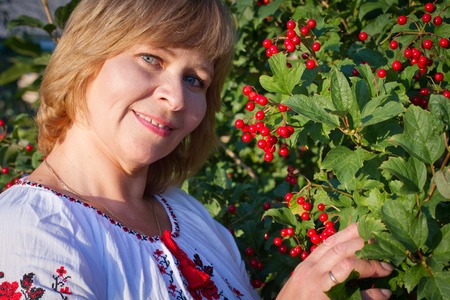 Happy woman with flower relaxes in the grass with a flower.の写真素材