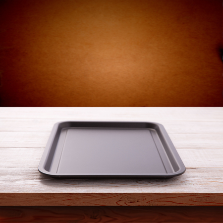 Empty baking tray for pizza on wooden table isolated close up top view square. Mock up for designの写真素材