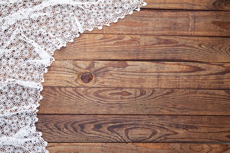 Old vintage wooden table with white tablecloth with lace. Top view mock up.の写真素材