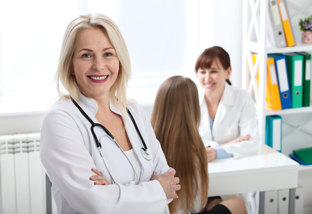 Doctor with stethoscope close up. Healthcare and medical concept - doctor with patient in hospitalの写真素材