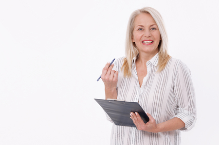 Business woman holds a pen and a folder with files isolated on white backgroundの写真素材