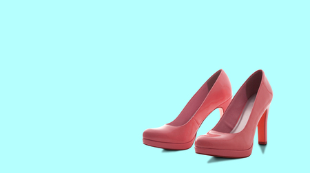 Fashion female pink shoes with heels. Womens footwear casual design isolated on blue background with free space for text.の写真素材