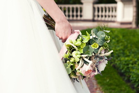 Bride holds a wedding bouquet, wedding dress , wedding details. Wedding ceremony concept.の写真素材