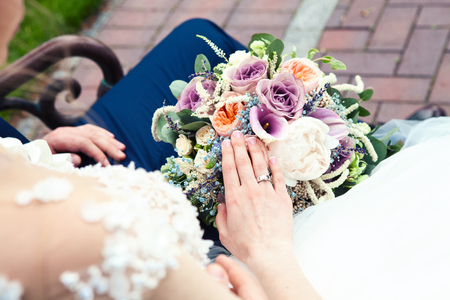 Bride holds a wedding bouquet, wedding dress, wedding accessories. Wedding ceremony concept.の写真素材
