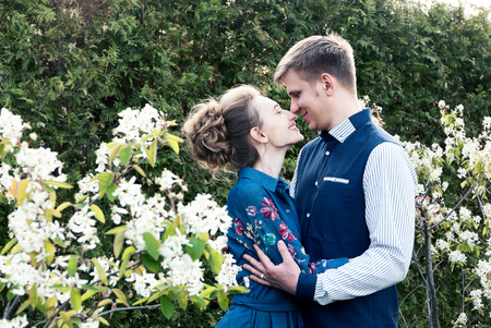 Bride and groom in park. Kissing couple newlyweds bride and groom at wedding in nature green forest are kissing photo portrait.Wedding Couple Wedding ceremony concept.の写真素材