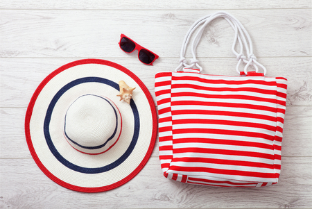 Summer accessories hat and bag on white wooden background.の写真素材