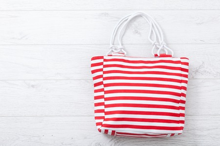 Summer accessories hat and bag on white wooden background.の写真素材